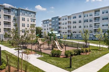 Playground with covered slides and surrounded by lawn